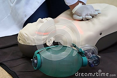 Chest compressions by a student on a simulation dummy during basic life support with an automatic external defibrillator. Stock Photo