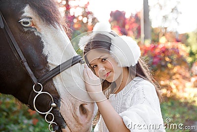 Chestnut horse together with her favorite owner young teenage girl. Colored outdoors horizontal summertime image. Stock Photo