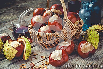 Chestnuts in basket and vials with tincture Stock Photo