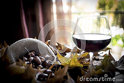 Chestnuts with glass of wine Stock Photo