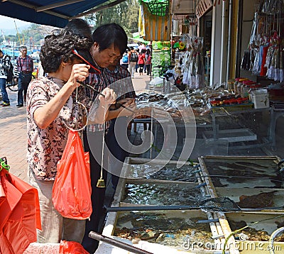 Buying and weighing fish at Cheung Chau Island Fish Market, Hong Kong Editorial Stock Photo