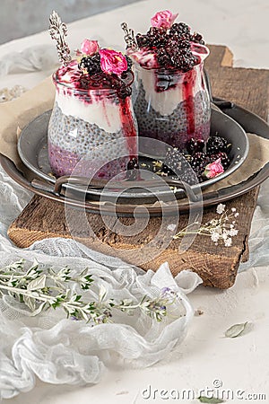 Chia pudding with blackberries and jam in glass jars. Concept of healthy eating, healthy lifestyle, dieting, fitness menu Stock Photo