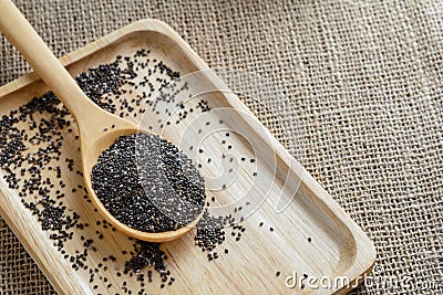 Chia seed on a wooden spoon against burlap background Stock Photo