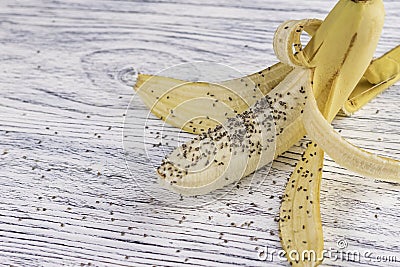 Chia seeds piled on peeled banana Stock Photo