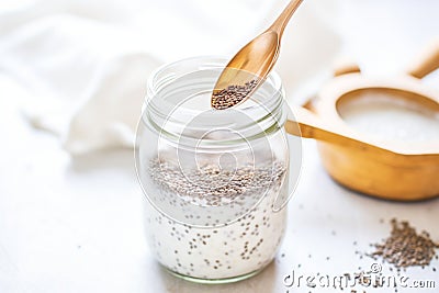 chia seeds soaking in a milk for an overnight shake Stock Photo