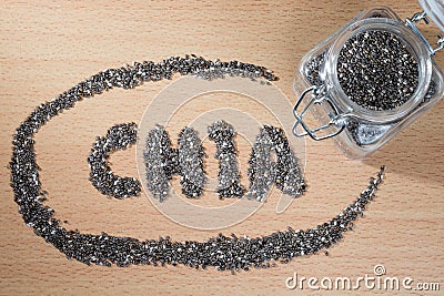 Chia word made from chia seeds on wooden plate Stock Photo