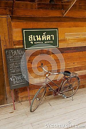 Old bicycle at the entrance to one of the hostels in Chiang Khan, Thailand. Editorial Stock Photo