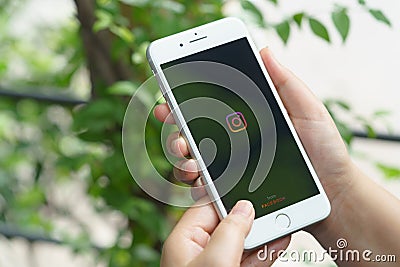 CHIANG MAI, THAILAND -Aug.1,2020:Woman holds Apple iPhone 8Plus with Instagram application on the screen at cafe.Instagram is a Editorial Stock Photo