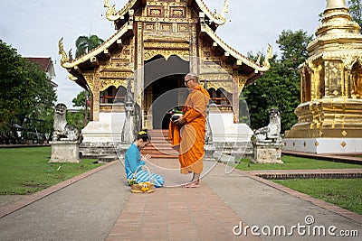 CHIANG-MAI, THAILAND. 13 AUGUST 2023 : Buddhist Lanna women offerings at Wat Phra Singh Temple in Chiang-Mai, Thailand. Editorial Stock Photo