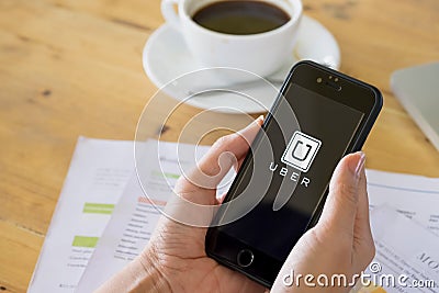 CHIANG MAI, THAILAND - JUL 14,2016 : A MAN hand holding Uber app Editorial Stock Photo