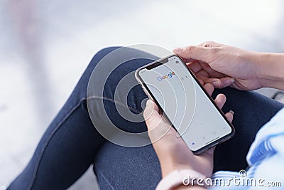 CHIANG MAI, THAILAND - Jul.27,2019: Woman holding Apple iPhone Xs with google apps for searching on www.google.com. Editorial Stock Photo