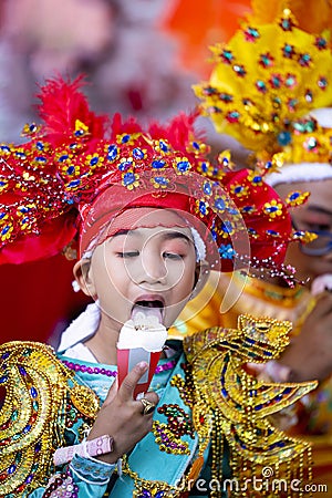 CHIANG MAI, THAILAND - MARCH 25 2023 : A boy eating ice cream in Poy Sang Long festival, A Ceremony of boys to become novice monk Editorial Stock Photo