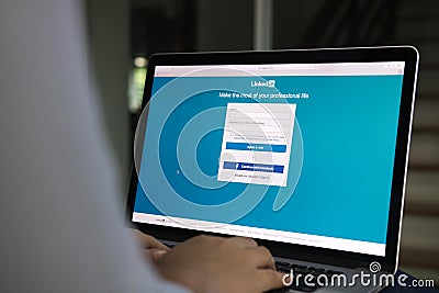 CHIANG MAI ,THAILAND - May 10, 2020 : Woman using computer looking LinkedIn login page in laptop screen. LinkedIn is social Editorial Stock Photo