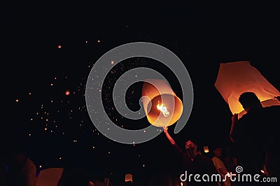 Chiang Mai - Thailand November 28, 2023 : Tourists happily celebrate releasing lanterns at the Loi Krathong Yi Peng Lantern Editorial Stock Photo