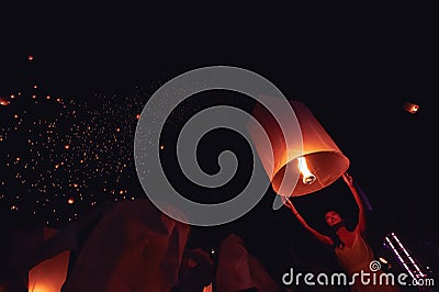 Chiang Mai - Thailand November 28, 2023 : Tourists happily celebrate releasing lanterns at the Loi Krathong Yi Peng Lantern Editorial Stock Photo