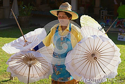 Thai women carries traditional bamboo umbrellas at the factory in Chiang Mai, Thailand. Editorial Stock Photo