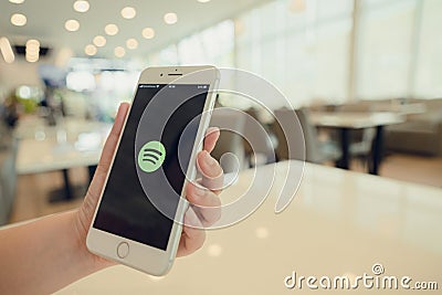 CHIANG MAI, THAILAND - Sep. 26,2020: Woman holds Apple iPhone 8Plus with Spotify app on screen. Editorial Stock Photo