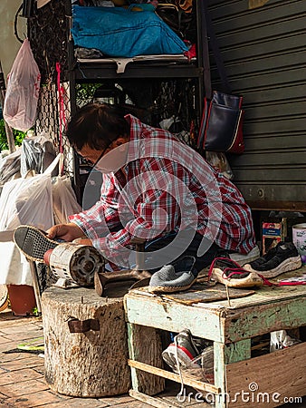Chiang Mai, Thailand - September 26, 2020: The Cobbler or shoemaker while working Editorial Stock Photo