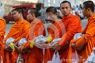 Young monks collect donations in Chiang Mai, Thailand Editorial Stock Photo