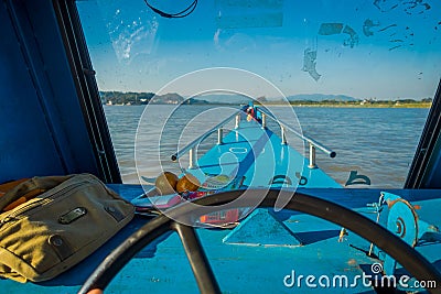 CHIANG RAI, THAILAND - FEBRUARY 01, 2018: Close up of the captain hands in the cabin sailing a boat in the waters of Editorial Stock Photo