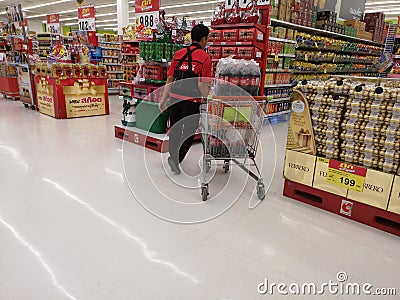 CHIANG RAI, THAILAND - FEBRUARY 15 : Unidentified male worker taking soft drink soda on shopping cart in supermarket on February Editorial Stock Photo