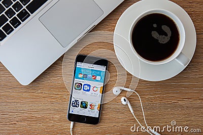 CHIANGMAI,THAILAND - FEBRUARY 5, 2015: Brand new Apple iPhone 5S with iTunes store application on the screen lying on a desk. Editorial Stock Photo