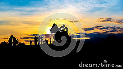 Silhouette Image of The statue of golden lion on a field with blue sky background at sunset or evening time, at Singha park Chiang Editorial Stock Photo