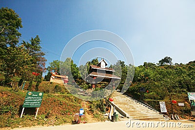 Concrete stair to Entrance wooden arch Thai-lanna style into Doi Pha Tang is beautiful Mountain in Thailand Editorial Stock Photo