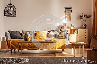 Chic black chandelier above couch in contemporary living room Stock Photo