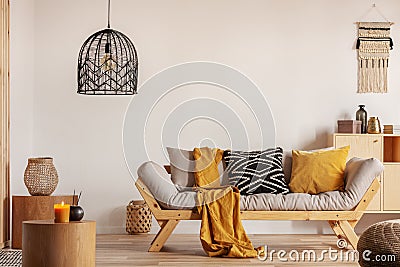 Chic black chandelier above couch in contemporary living room Stock Photo