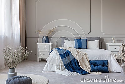 Chic feminine bedroom interior in trendy apartment, copy space on empty wall Stock Photo