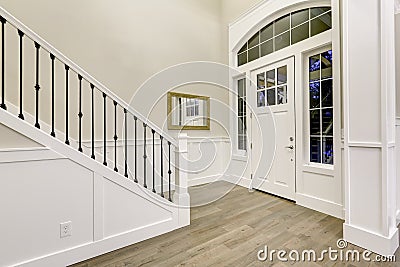 Chic white entryway design accented with high ceiling Stock Photo