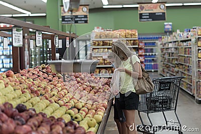 Chicago,IL- August 21, 2021:Mother and child wearing masks shopping at supermarket for editorial use only Editorial Stock Photo