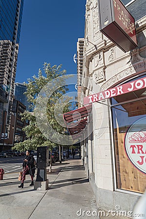 Customer exit Trader Joe`s discount retailer in downtown Chicago Editorial Stock Photo