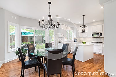 Dining room and white kitchen with view outside. Editorial Stock Photo