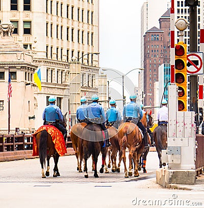 Chicago Mounted Police crossing the DuSable Bridge on Michigan Avenue Editorial Stock Photo