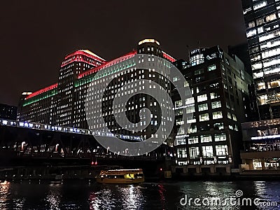 Chicago`s el train passes through an illuminated cityscape with Christmas holiday decorations. Editorial Stock Photo