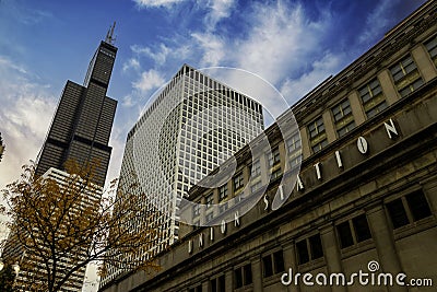 The Chicago Union Station building surrounded by skyscrapers and office buildings, yellow autumn trees with blue sky and clouds Editorial Stock Photo