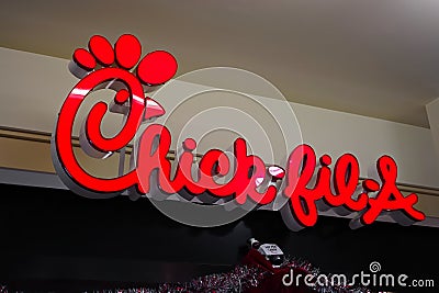Chick-fil-A fast food restaurant chain logo sign closeup in Ala Moana shopping mall food court. Editorial Stock Photo
