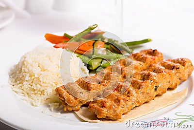 Chicken Adana Kebap Served with Rice Pilaf Vegetables and Red Vi Stock Photo