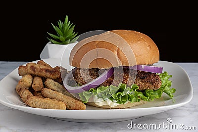 chicken breast top with onions on a brioche bun Stock Photo