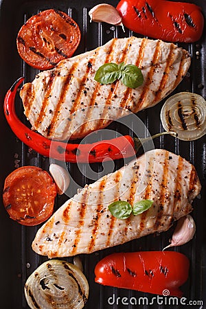 Chicken breast with vegetables in a pan grill top view vertical Stock Photo