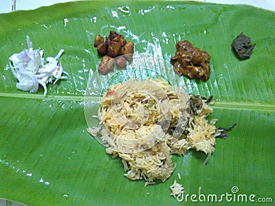 Chicken briyani, chicken gravy, chicken fry, raita, Pudina chutney served in traditional banana leaf Stock Photo