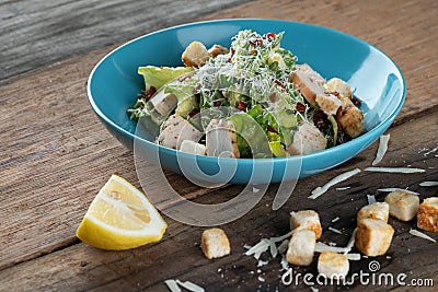 Chicken Cesar salad with croutons, grated cheese and lemon Stock Photo