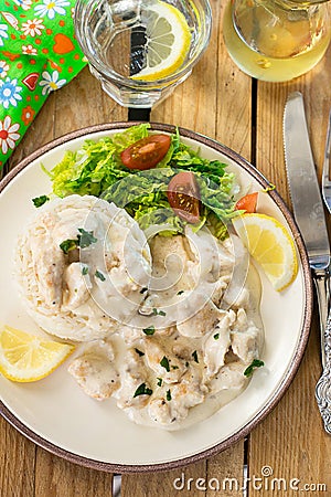 Chicken in cheesy creamy sauce served with rice Stock Photo