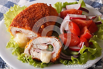 Chicken cordon bleu and vegetable salad closeup. horizontal Stock Photo
