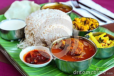 Chicken curry thali served with dry potato and caulifower curry rasam curd and papad Stock Photo
