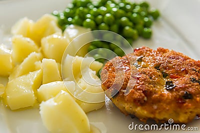 Chicken cutlet with green peas Stock Photo