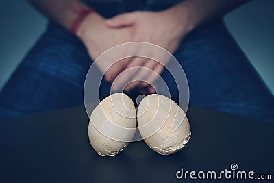 Chicken eggs and Shell eggs symbol penis, Excruciating pain in the groin. The concept of male sexual problems. Punch in the groin. Stock Photo