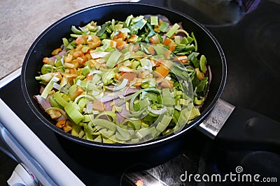 Chicken with fresh vegetables on a frying pan Stock Photo